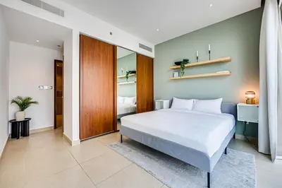 a bedroom with a large white bed in a room at Luxurious apartment in Dubai Marina in Dubai