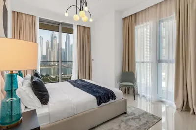 a bedroom with a bed and a large window at Apartments Beach Isle Tower, 1BR in Dubai