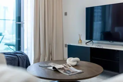 a living room with a coffee table and a tv at Apartments Beach Isle Tower, 1BR in Dubai