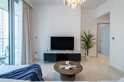 a living room with a tv and a coffee table at Apartments Beach Isle Tower, 1BR in Dubai