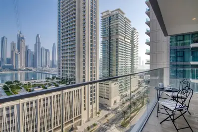 a balcony with a table and a view of a city at Apartments Beach Isle Tower, 1BR in Dubai