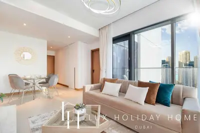 a living room with a couch and a table at LUX The Vida Marina Residence 3 in Dubai