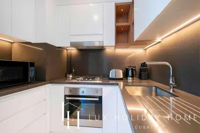 a kitchen with a sink and a microwave at LUX The Vida Marina Residence 3 in Dubai