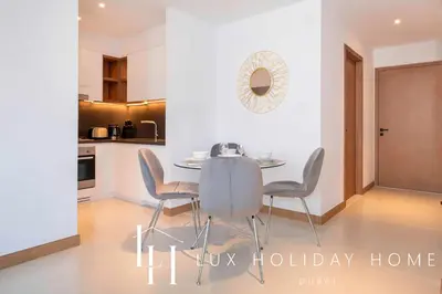 a kitchen and dining room with a table and chairs at LUX The Vida Marina Residence 3 in Dubai
