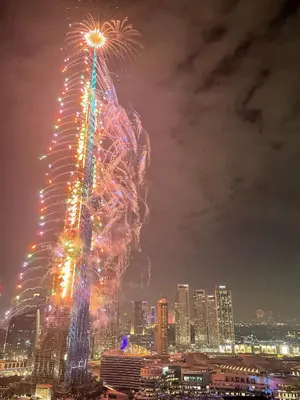 a firework display in front of a city at night at Prestige Living 2BR with Full Burj Khalifa and Fountain View by Auberge in Dubai