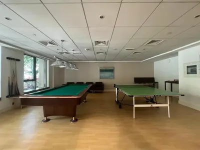 a billiard room with a table and a pool at Prestige Living 2BR with Full Burj Khalifa and Fountain View by Auberge in Dubai