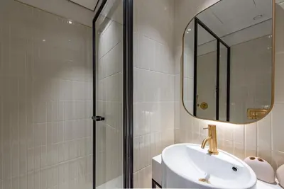 a bathroom with a shower and a sink and a mirror at Studio with Burj Khalifa View - Upside Living in Dubai