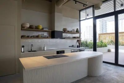 a kitchen with a white counter and a large window at Studio with Burj Khalifa View - Upside Living in Dubai