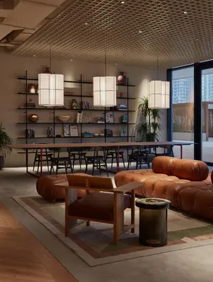 a dining room with a table and leather furniture at Studio with Burj Khalifa View - Upside Living in Dubai