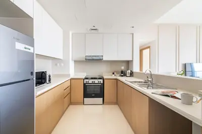 a large kitchen with a stove and a sink at GuestReady - Sophistication Skyview Harbour in Dubai