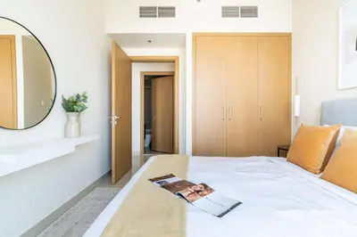 a bedroom with a white bed with a mirror at GuestReady - Sophistication Skyview Harbour in Dubai