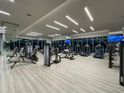 a gym with several treadmills and machines in a building at GuestReady - Sophistication Skyview Harbour in Dubai