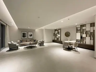 a living room with a couch and a table and chairs at GuestReady - Sophistication Skyview Harbour in Dubai