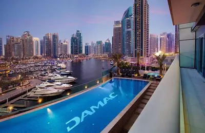a large swimming pool on top of a building with a city at Luxurious Escape meets Fendi Design in Iconic Building on Top Location in Dubai Marina in Dubai