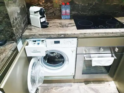 a white washer and dryer in a kitchen at Luxurious Escape meets Fendi Design in Iconic Building on Top Location in Dubai Marina in Dubai