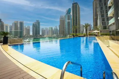 a large swimming pool with a city skyline in the background at Luxurious Escape meets Fendi Design in Iconic Building on Top Location in Dubai Marina in Dubai