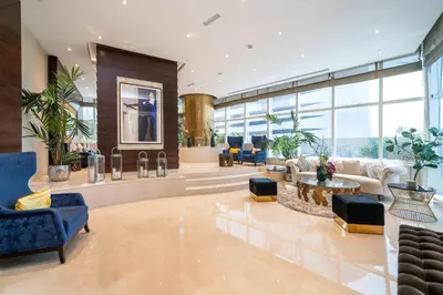 a lobby with blue chairs and tables in a building at Luxurious Escape meets Fendi Design in Iconic Building on Top Location in Dubai Marina in Dubai