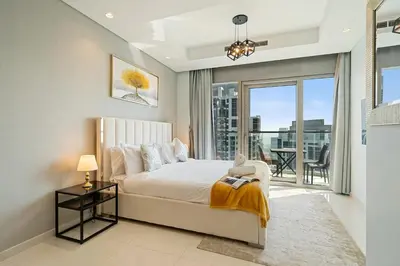 a bedroom with a bed and a large window at High Floor 2 Bedroom Gem - Burj Khalifa Views in Dubai