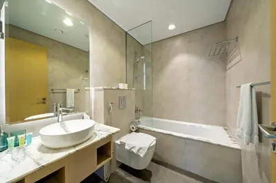 a bathroom with a sink and a bath tub at High Floor 2 Bedroom Gem - Burj Khalifa Views in Dubai