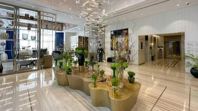 a room with a bunch of potted plants in it at High Floor 2 Bedroom Gem - Burj Khalifa Views in Dubai
