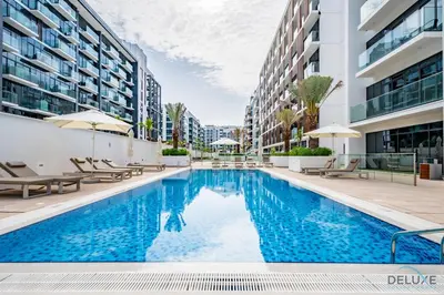 a swimming pool in the middle of a building at Beautiful Studio at Azizi Riviera 17, Al Merkadh by Deluxe Holiday Homes in Dubai