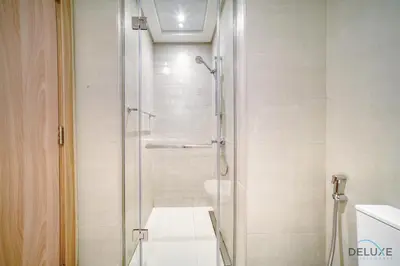 a bathroom with a shower with a glass door at Beautiful Studio at Azizi Riviera 17, Al Merkadh by Deluxe Holiday Homes in Dubai