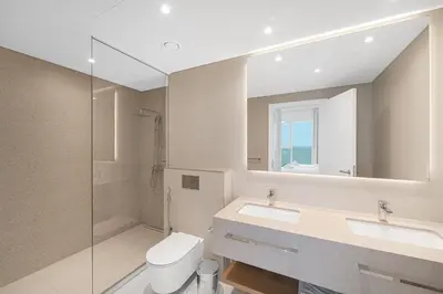 a bathroom with a toilet and a sink and a mirror at 3Bed Private Beach - Belle vie à La Vie Dubai in Dubai