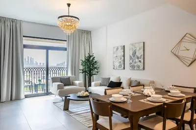 a living room with a table and chairs and a couch at Apartment 1BDR in Madinat Jumeirah I Asayel 3 in Dubai