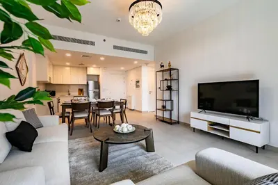 a living room with a couch and a tv and a table at Apartment 1BDR in Madinat Jumeirah I Asayel 3 in Dubai