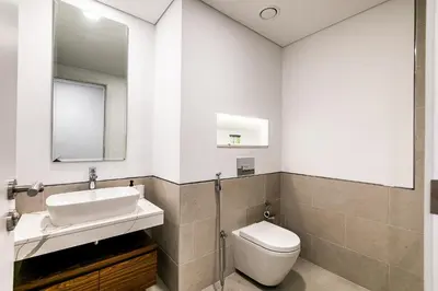 a bathroom with a sink and a toilet and a mirror at Apartment 1BDR in Madinat Jumeirah I Asayel 3 in Dubai