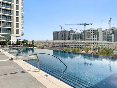 a swimming pool in a city with tall buildings at Amazing 2br with a lagoon view in Creek Harbour in Dubai