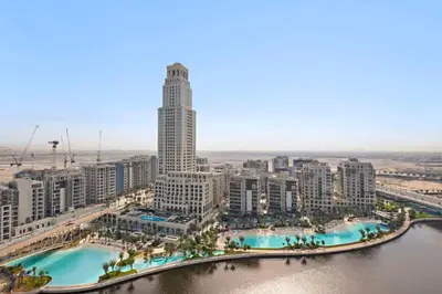 an aerial view of a city with a tall building at Amazing 2br with a lagoon view in Creek Harbour in Dubai