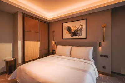 a bedroom with a large white bed in a room at THE CLOSEST building to Burj Khalifa with Fountain View in Address Opera Residence in Dubai
