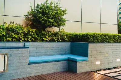 a blue bench sitting on a brick wall at THE CLOSEST building to Burj Khalifa with Fountain View in Address Opera Residence in Dubai