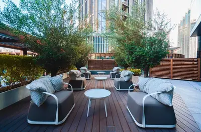 a group of chairs and tables on a patio at THE CLOSEST building to Burj Khalifa with Fountain View in Address Opera Residence in Dubai