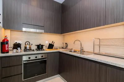 a kitchen with a stove and a sink at Elite Escape Holiday Home - 1 BHK Getaway with Dubai Mall Access - 1502 in Dubai