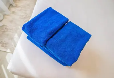 a blue towel sitting on top of a white couch at New Arabian Shams 2 JBR Sea View in Dubai