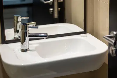 a white sink in a bathroom with a mirror at Whispers of the Wind by Lagom Vacation Homes in Dubai