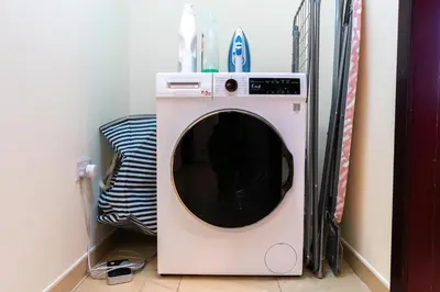 a washer and dryer sitting in a room at 7 Beds / JBR / Sea, JBR Beach and Ain Dubai Views / 3 min walk from JBR Beach / Large Groups and Families / Ideal Vacation Location in Dubai