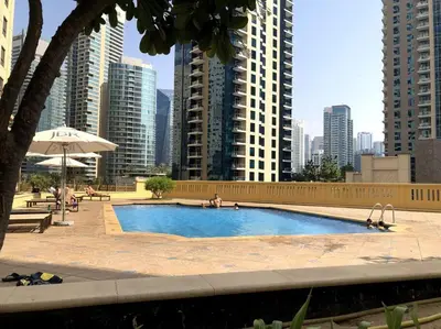 a large swimming pool in a city with tall buildings at 7 Beds / JBR / Sea, JBR Beach and Ain Dubai Views / 3 min walk from JBR Beach / Large Groups and Families / Ideal Vacation Location in Dubai