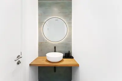 a bathroom with a white sink and a mirror at Luxury Living w private beach and Burj AlArab view in Dubai