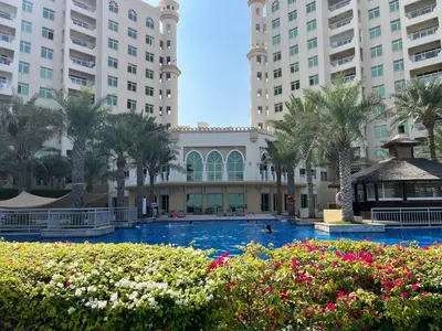 a swimming pool at a resort with tall buildings at Luxury Living w private beach and Burj AlArab view in Dubai