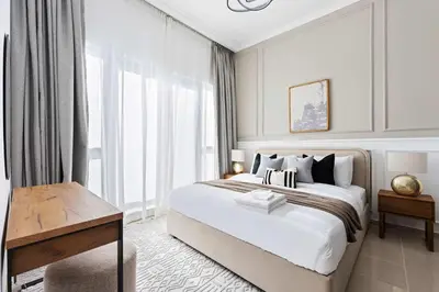 a white bedroom with a large bed and a window at Silkhaus in Dubai Marina Heart, Opposite to Marina Mall in Dubai
