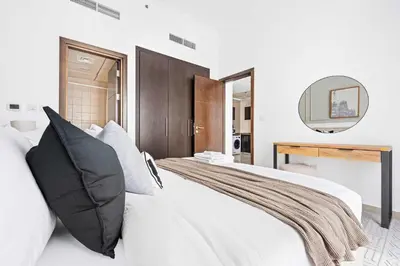 a bedroom with a large white bed with a mirror at Silkhaus in Dubai Marina Heart, Opposite to Marina Mall in Dubai