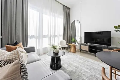 a living room with a couch and a tv at Silkhaus in Dubai Marina Heart, Opposite to Marina Mall in Dubai