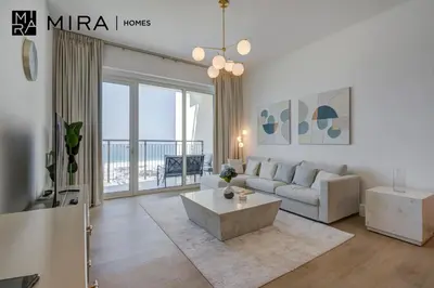 a living room with a couch and a table at Mira Holiday Homes - Newly 1 bedroom with sea view in Dubai