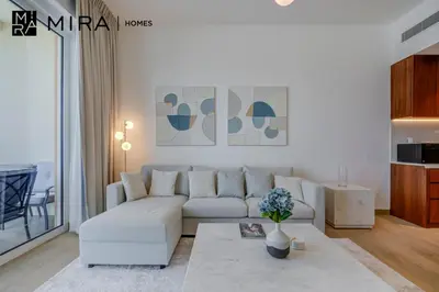 a living room with a couch and a table at Mira Holiday Homes - Newly 1 bedroom with sea view in Dubai