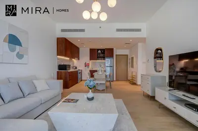 a living room with a couch and a table at Mira Holiday Homes - Newly 1 bedroom with sea view in Dubai