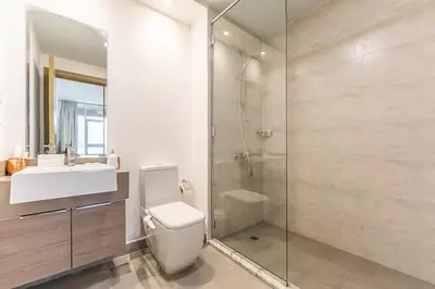 a bathroom with a toilet and a sink and a shower at HAVN - 2 Bedroom Apartment in Bloom Tower, JVC in Dubai