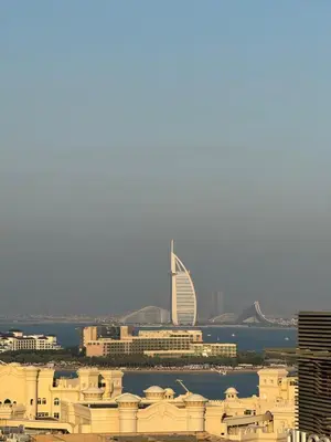 a view of a city with a tall building at Beachside Bliss: Stylish New Studio at Seven Palm in Dubai